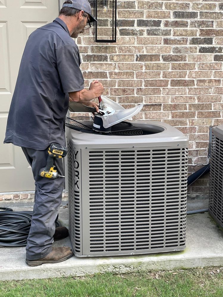 HVAC technician repairs a York air conditioner unit. AC maintenance helps with energy efficiency. Call for AC repair in Southlake, TX.